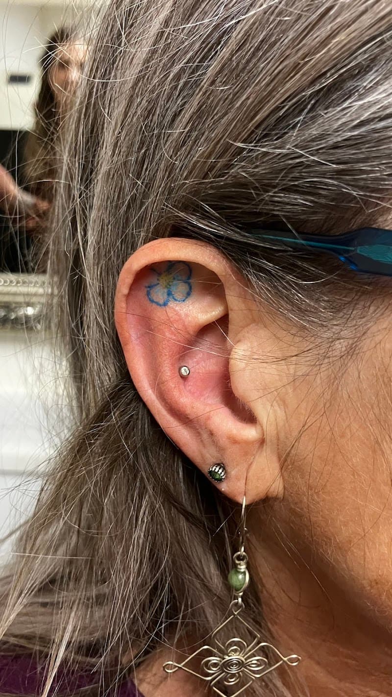 Kleine blauwe vergeet-mij-nietje bloem in de oorschelp.