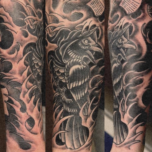 Zwart-wit tattoo van een pestmeester met vogelmasker en golven op de onderarm.