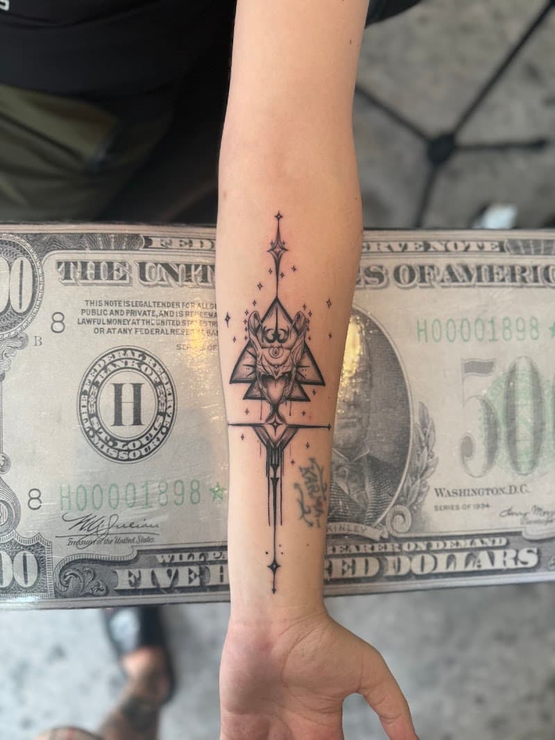 Fineline tattoo van een geometrische duivel/demon op de onderarm.