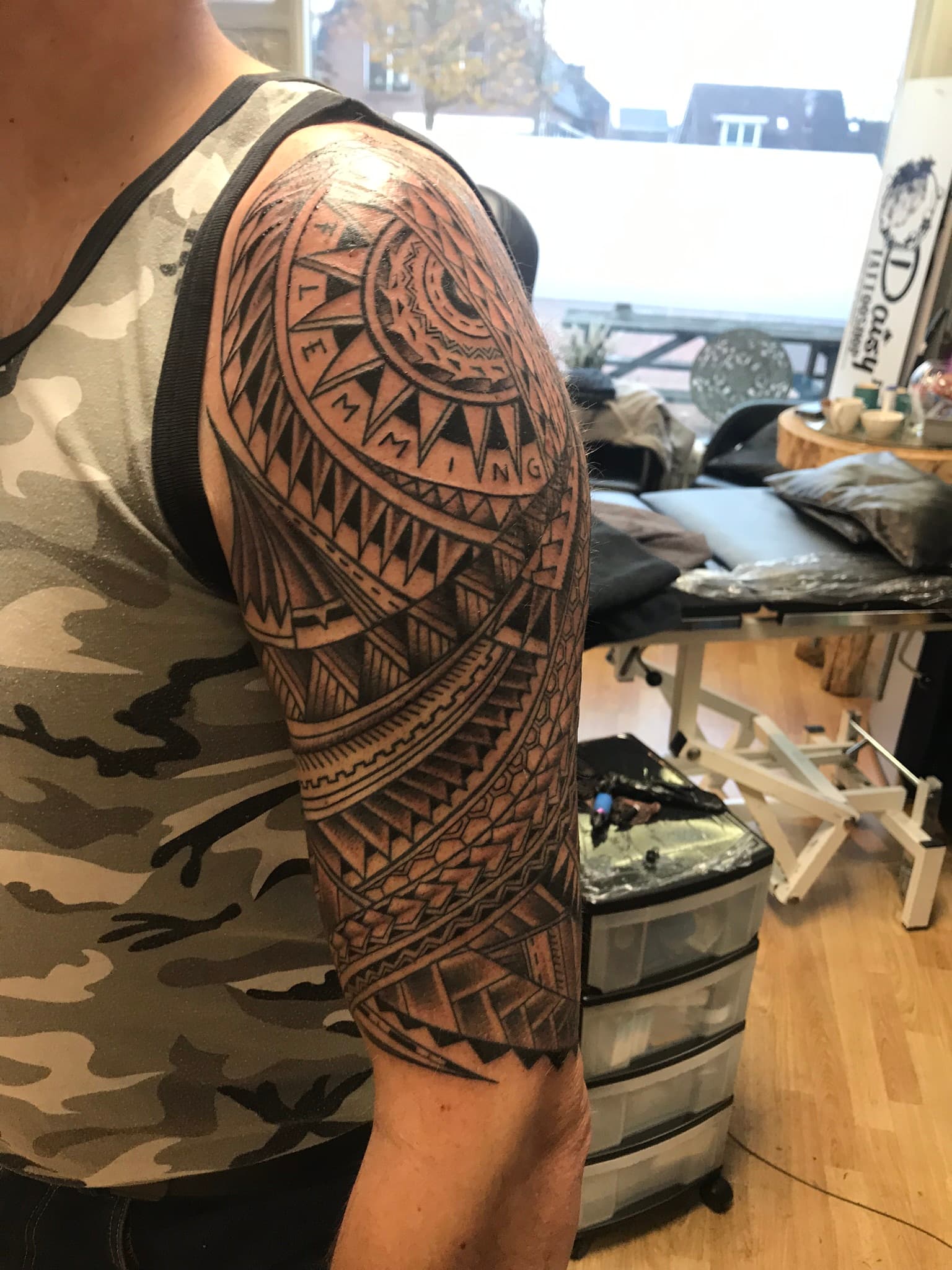 Grote Polynesische tribal half-sleeve tattoo op de bovenarm.
