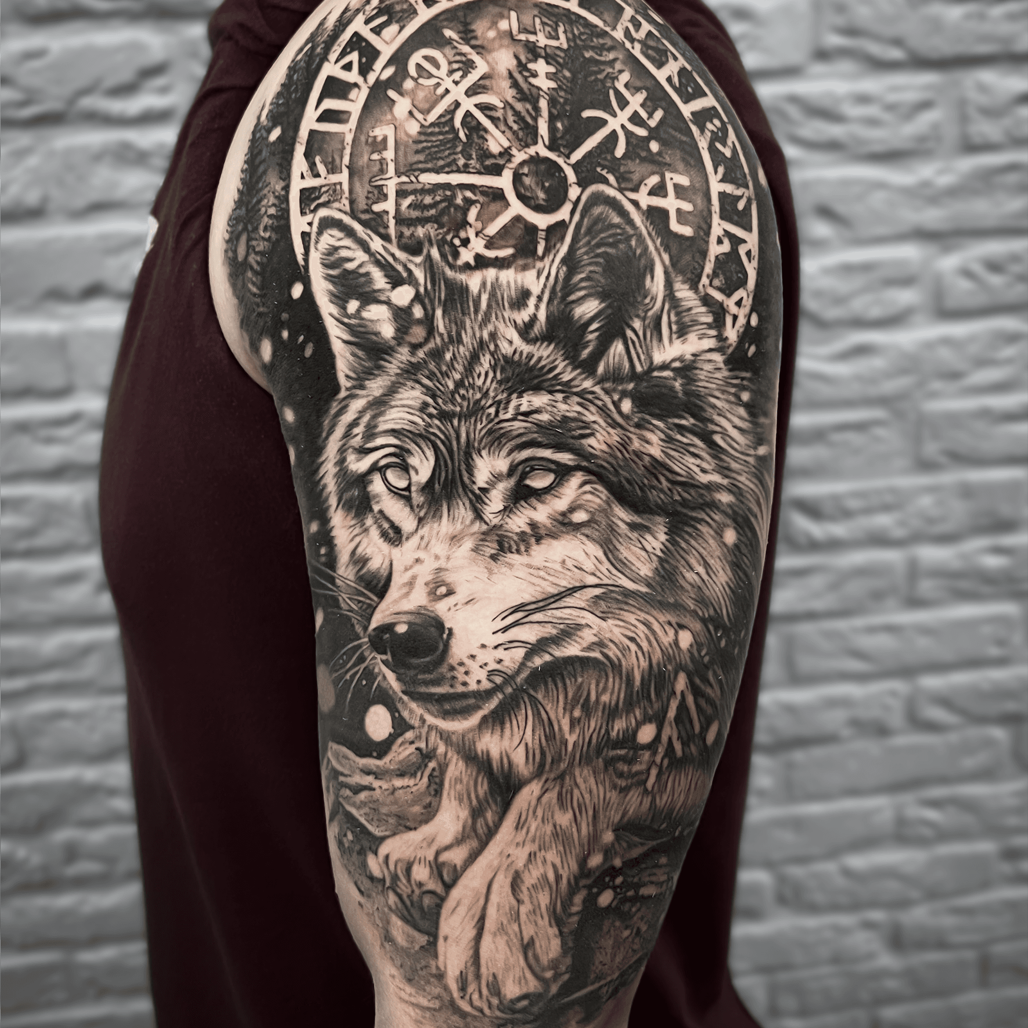 Realistische wolf met Vegvisir kompas op bovenarm.