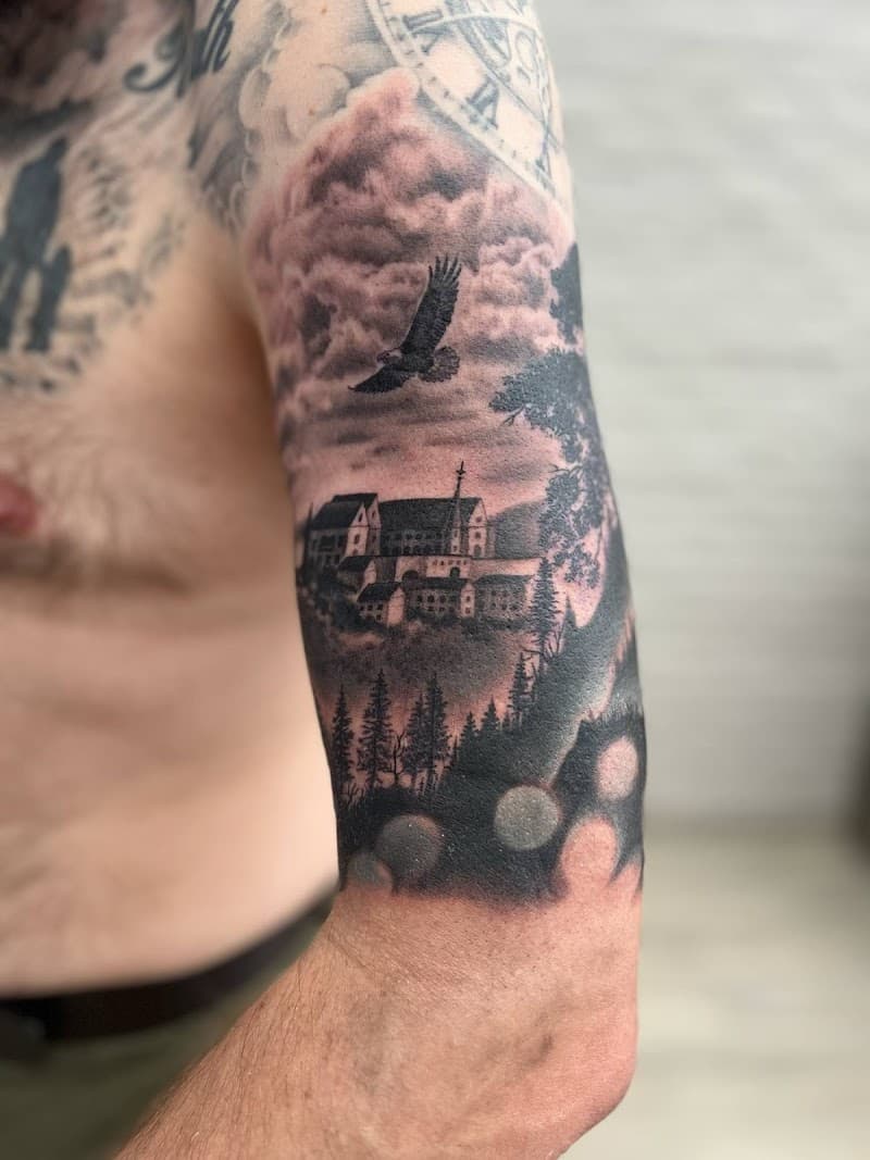 Realistisch landschap met kasteel, adelaar en bos op bovenarm.