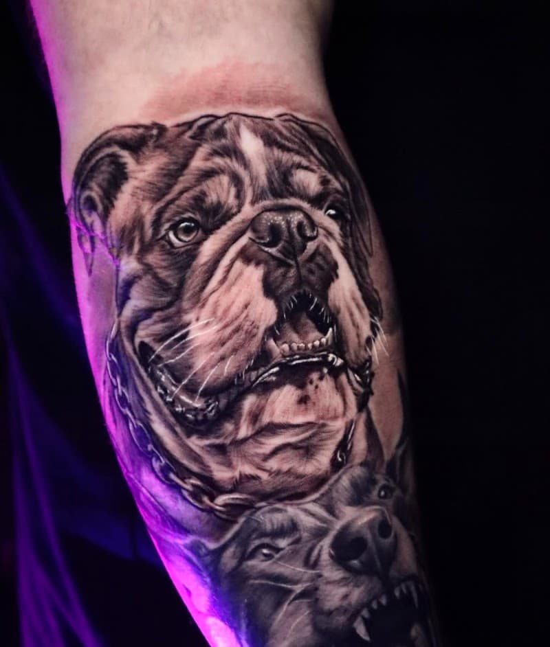 Realistische zwart-wit tattoo van twee hondenkoppen, een bulldog en een andere hond.