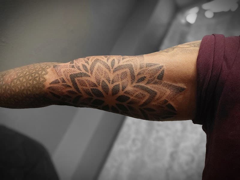 Grote dotwork mandala tattoo op de binnenkant van de bovenarm.
