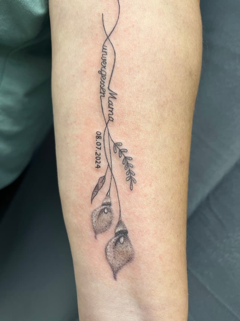 Fineline tattoo met calla lelies, tekst 'unvergessen Mama' en datum.