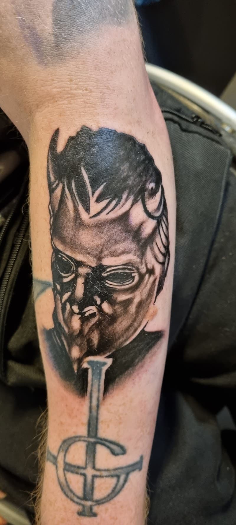 Blackwork portret van een Ghost Ghoul met het bandlogo eronder.