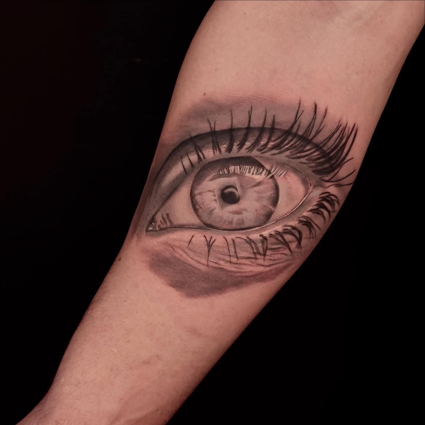 Realistisch oog met wimpers op onderarm.