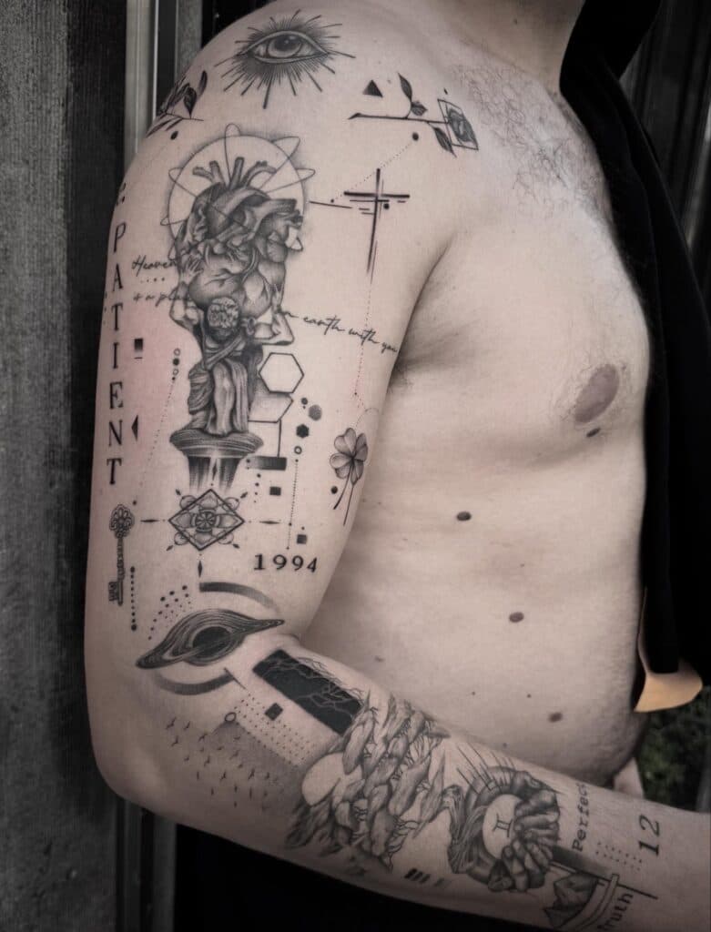 Gedetailleerde blackwork sleeve met anatomisch hart, standbeeld, geometrie en tekst.