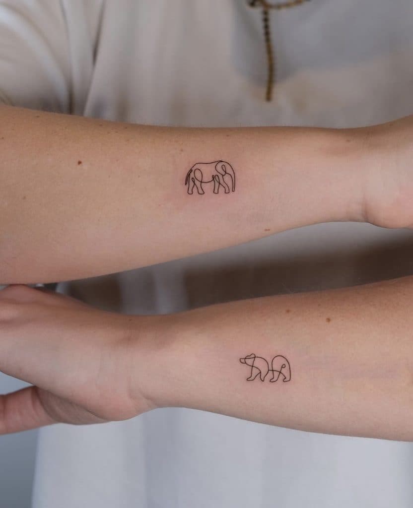 Minimalistische fineline olifant en beer tattoos op onderarmen.