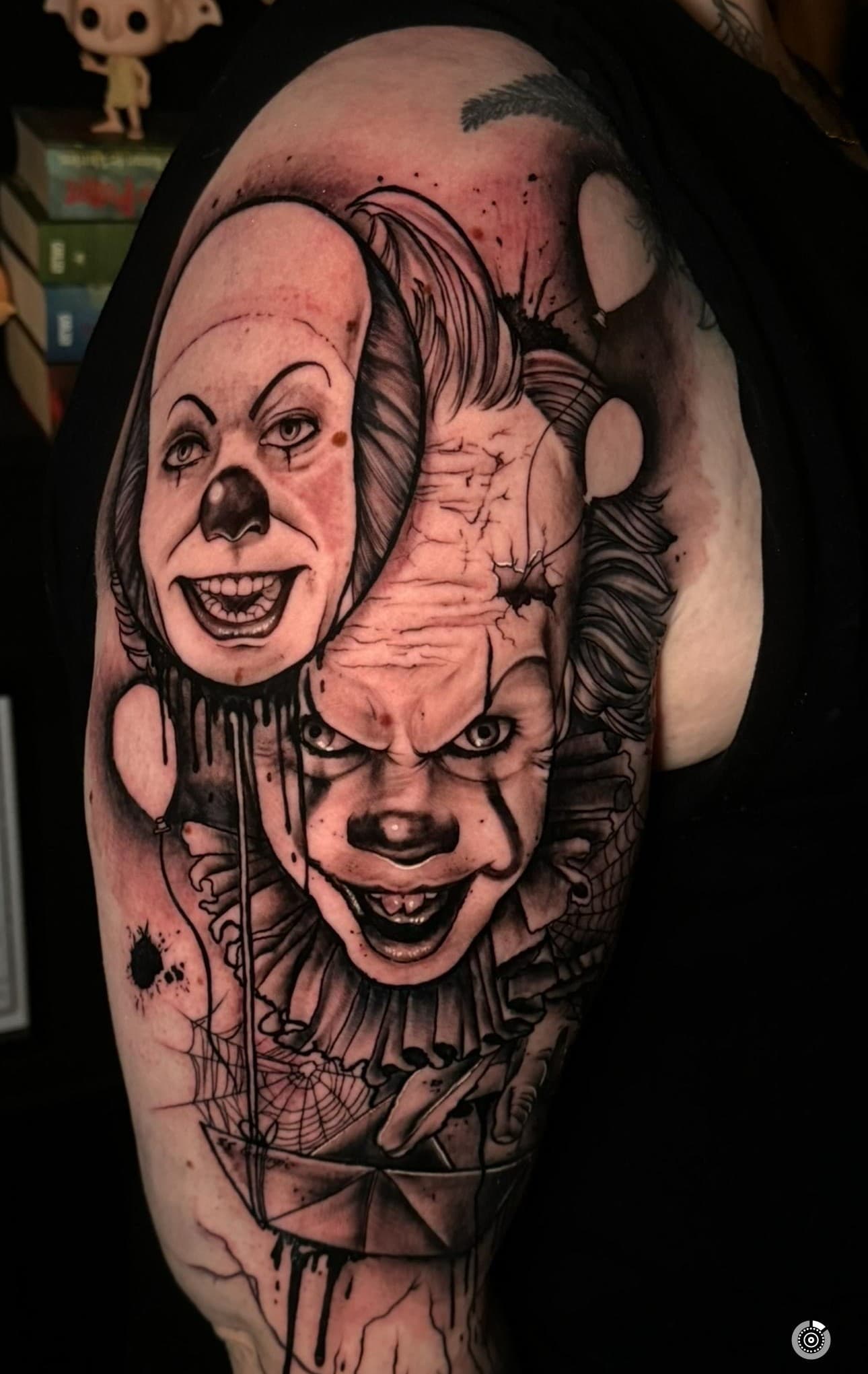 Realistische Pennywise clown met masker en ballon op bovenarm.