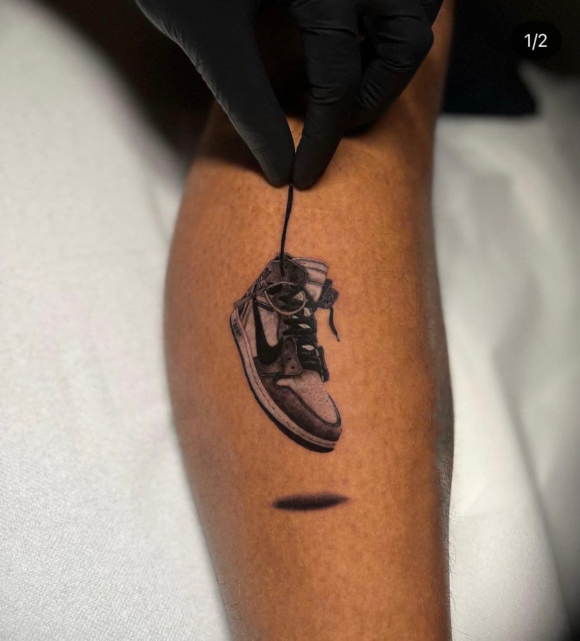 Realistische Nike Air Jordan sneaker hangend aan veter op onderbeen.